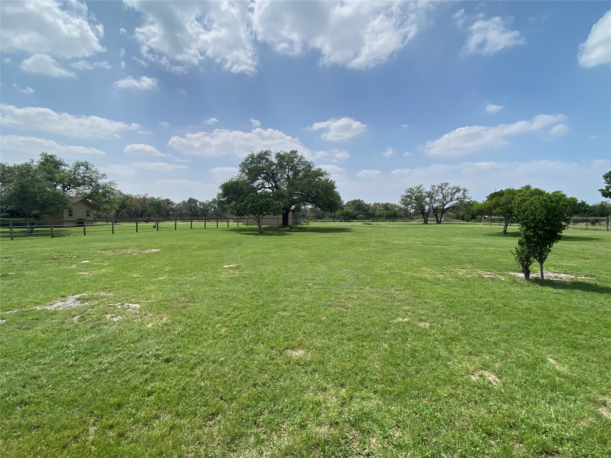 140 Oak Ridge Road Georgetown, TX 78628 - Photo 21 of 40 Expansive green lawn area featuring mature trees and a perimeter fence