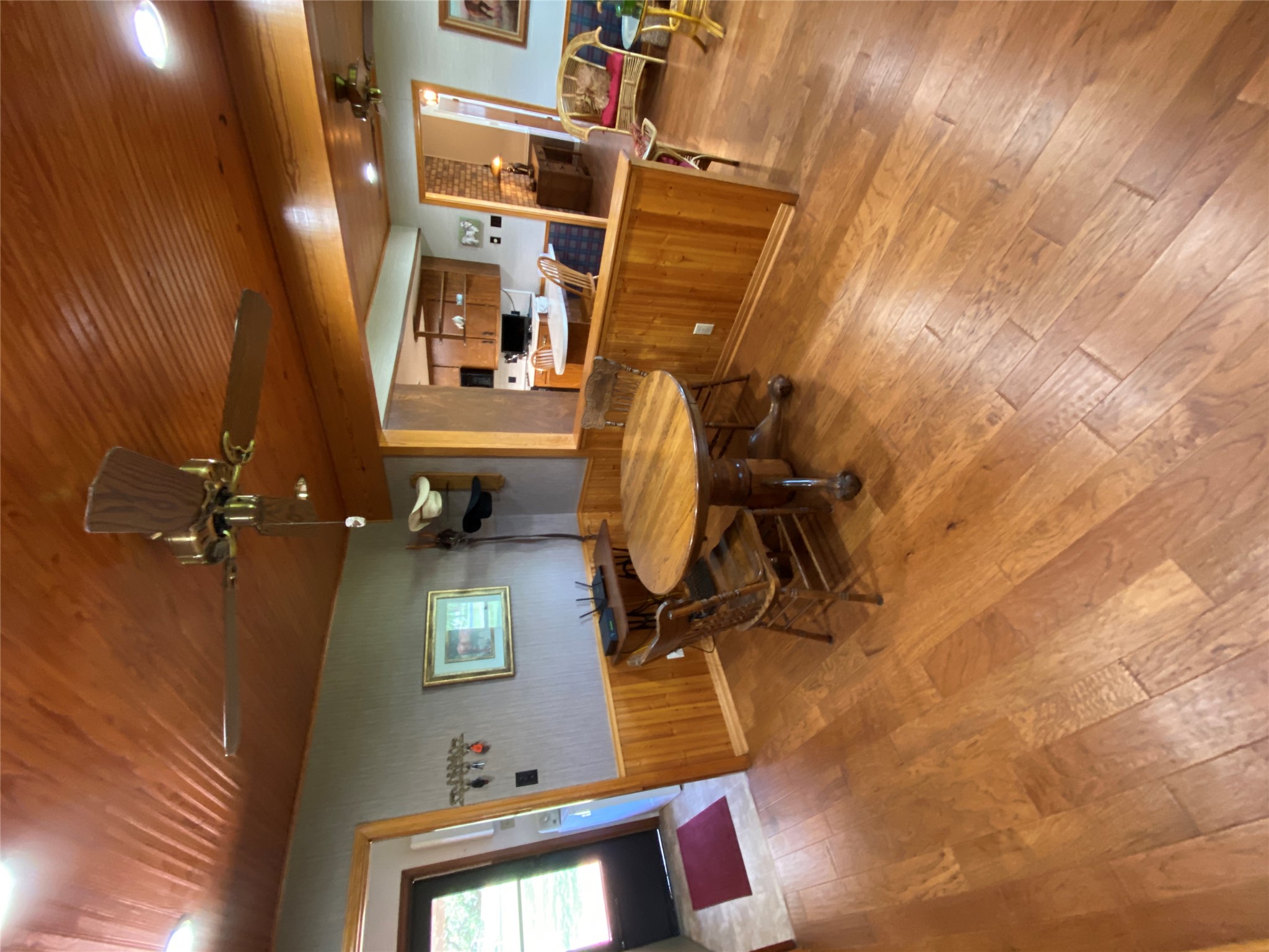 140 Oak Ridge Road Georgetown, TX 78628 - Photo 23 of 39 Dining space featuring ceiling fan, wainscoting, light wood-style floors, wood walls, and wood ceiling