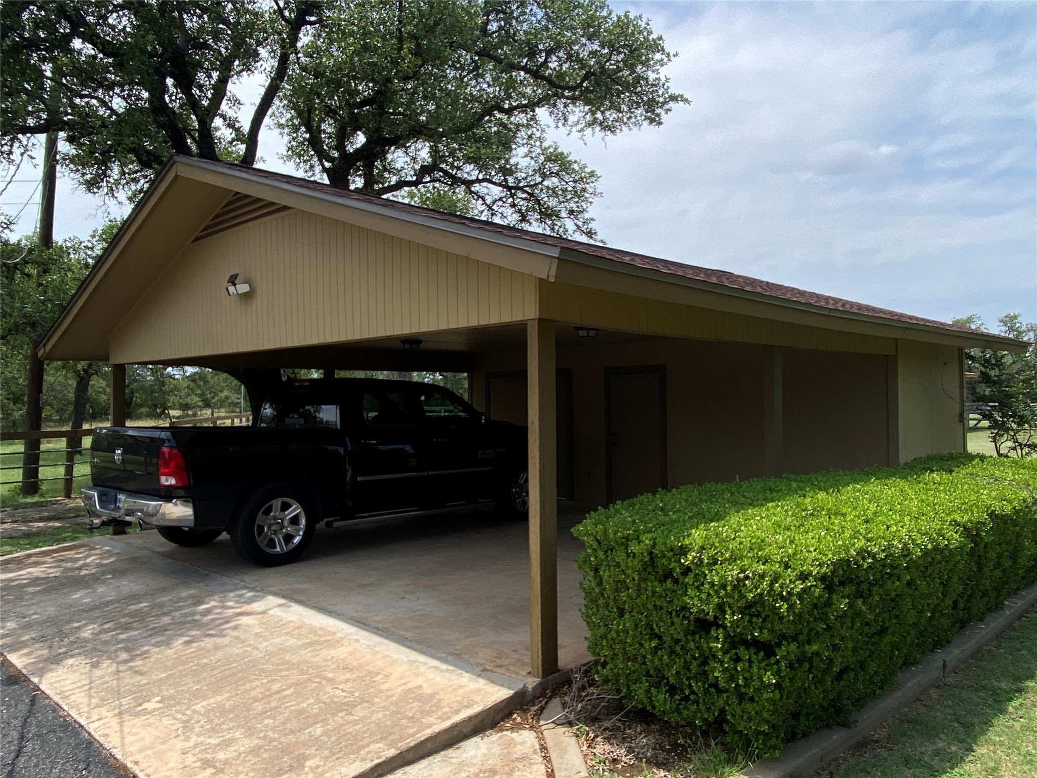 140 Oak Ridge Road Georgetown, TX 78628 - Photo 23 of 40 View of parking featuring a carport and concrete driveway