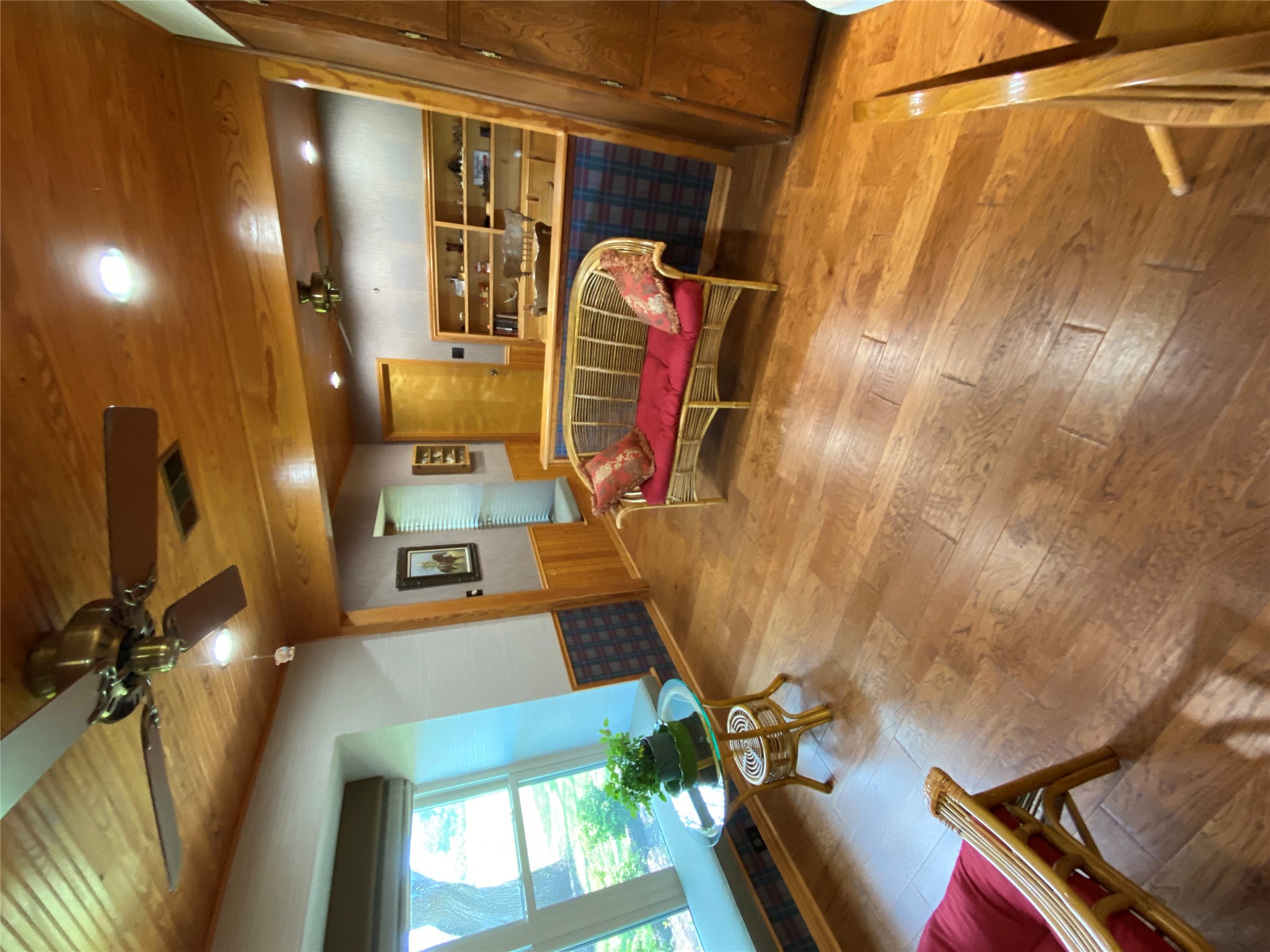 140 Oak Ridge Road Georgetown, TX 78628 - Photo 28 of 40 Living area featuring a wainscoted wall, hardwood / wood-style floors, a ceiling fan, wood ceiling, and wooden walls