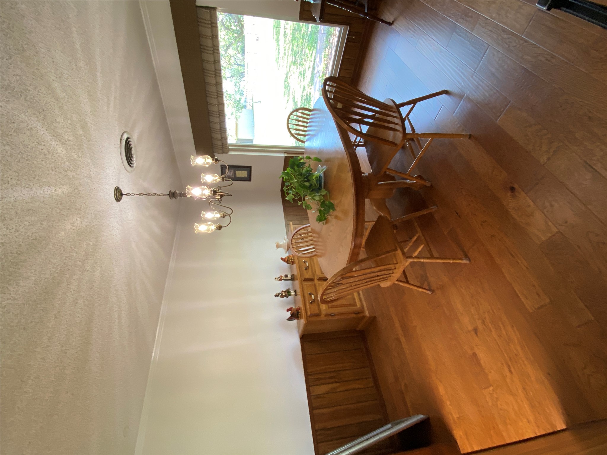 140 Oak Ridge Road Georgetown, TX 78628 - Photo 30 of 40 Dining area featuring wood walls, wainscoting, a textured ceiling, suspended lighting, and dark wood-type flooring