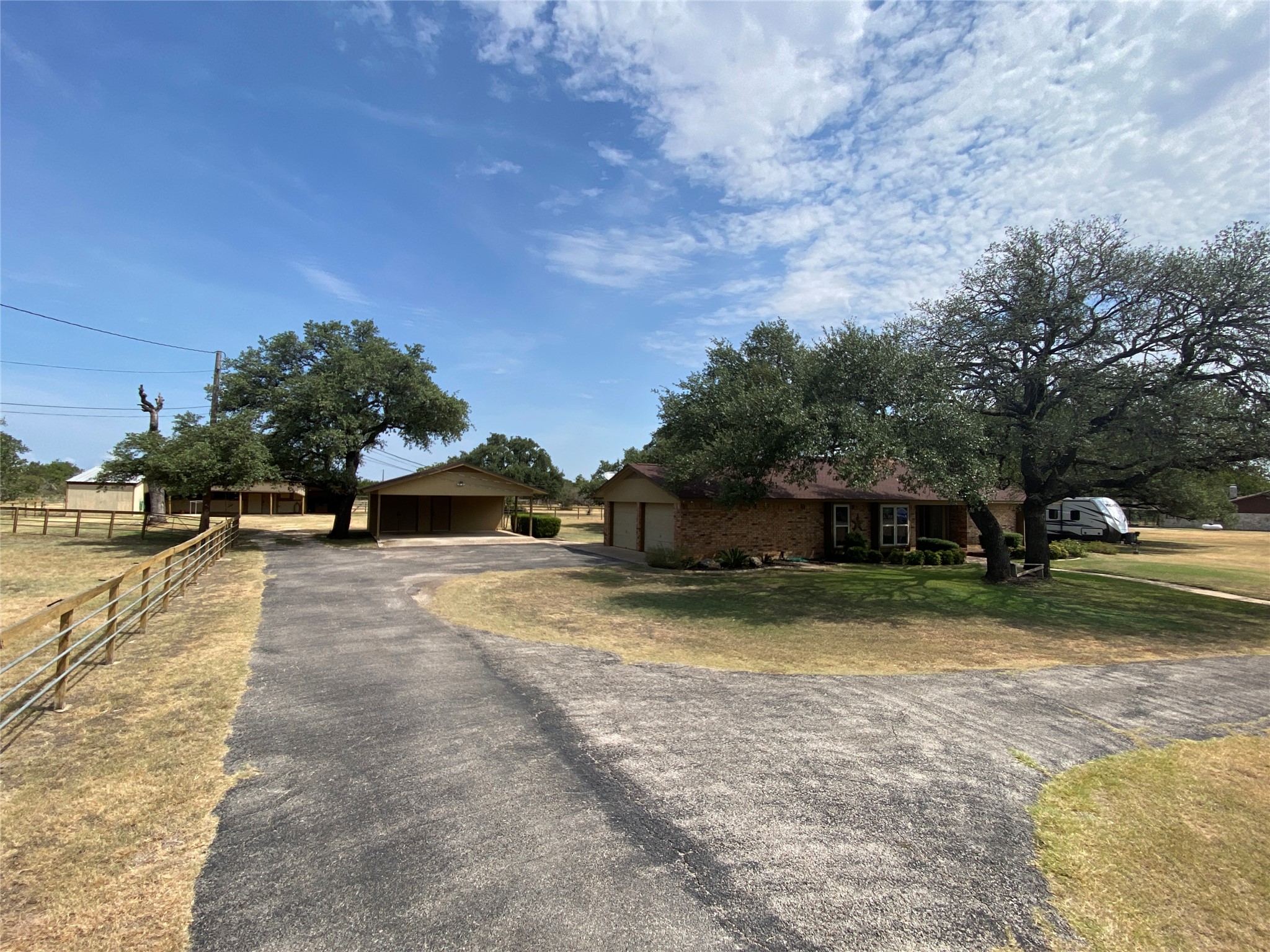 140 Oak Ridge Road Georgetown, TX 78628 - Photo 3 of 39 View of front of home featuring a garage, brick siding, an outdoor structure, and driveway