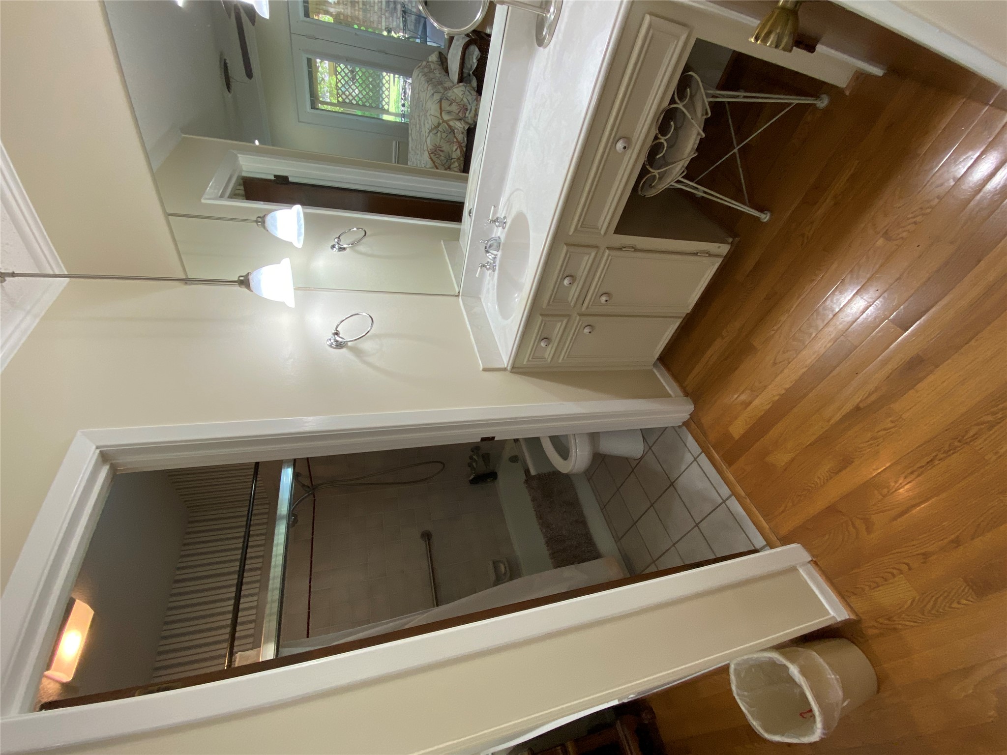 140 Oak Ridge Road Georgetown, TX 78628 - Photo 34 of 39 Ensuite bathroom with light wood-style floors, vanity, and shower combination