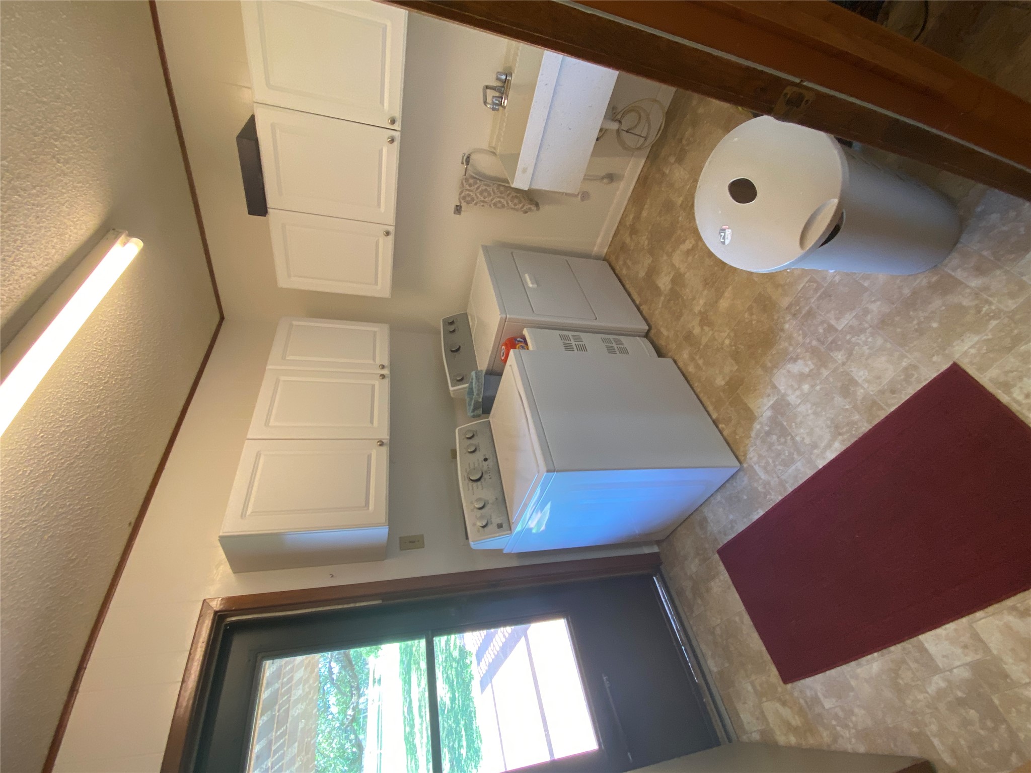 140 Oak Ridge Road Georgetown, TX 78628 - Photo 39 of 39 Laundry area with a textured ceiling, independent washer and dryer, and cabinet space