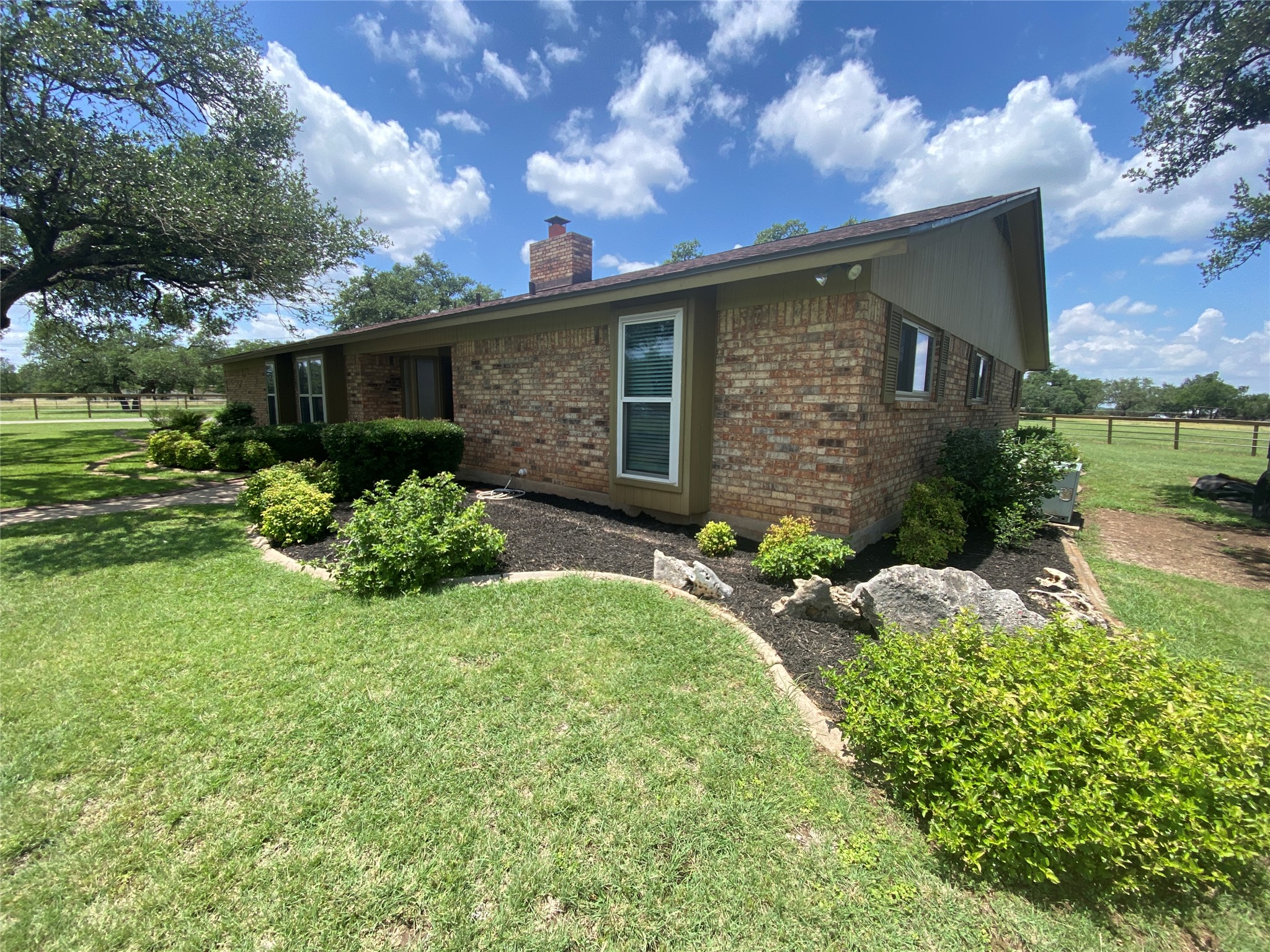 140 Oak Ridge Road Georgetown, TX 78628 - Photo 8 of 40 View of property exterior with brick siding and a chimney