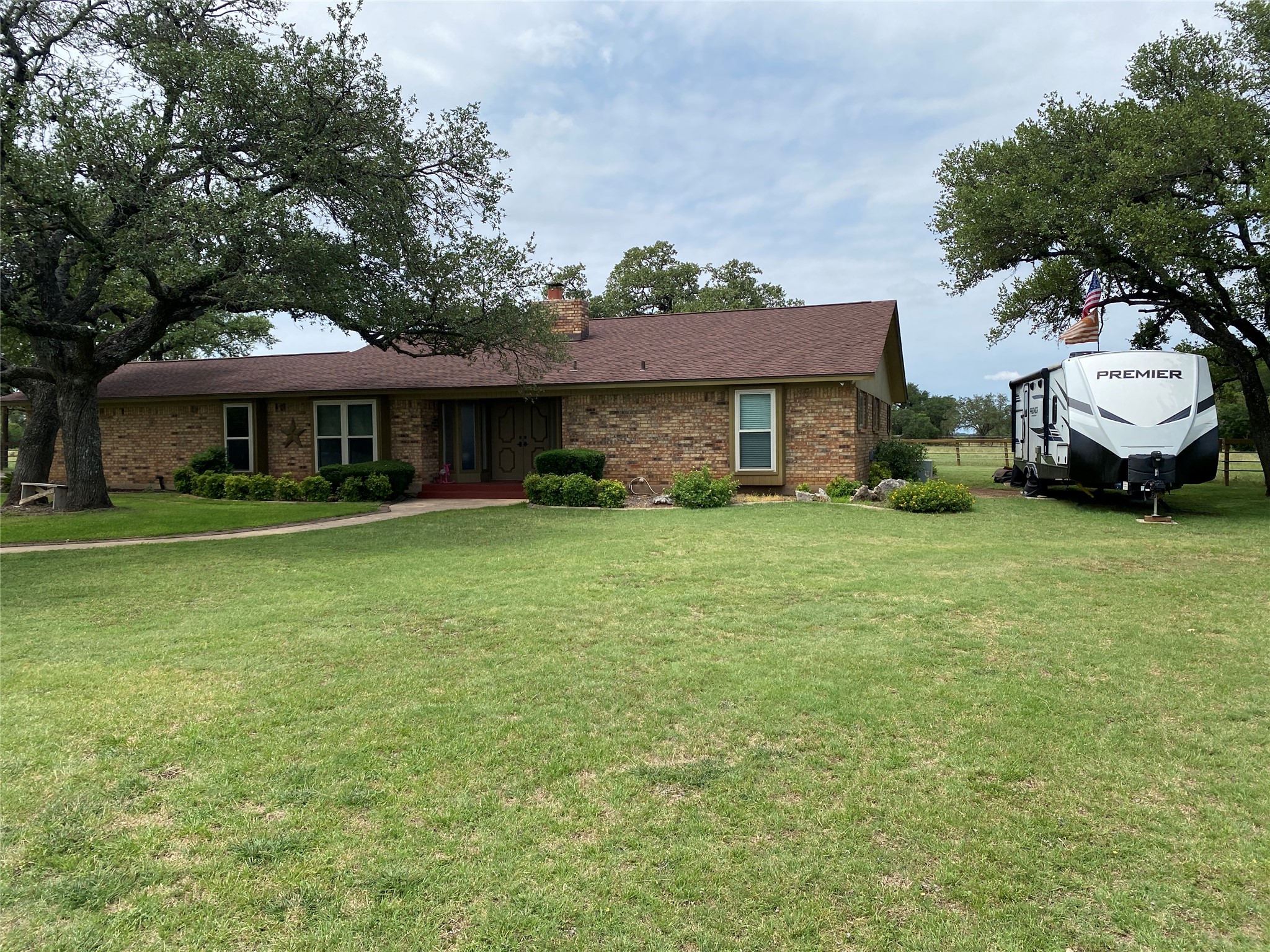 140 Oak Ridge Road Georgetown, TX 78628 - Photo 8 of 39 Ranch-style house featuring brick siding, a front lawn, and a chimney
