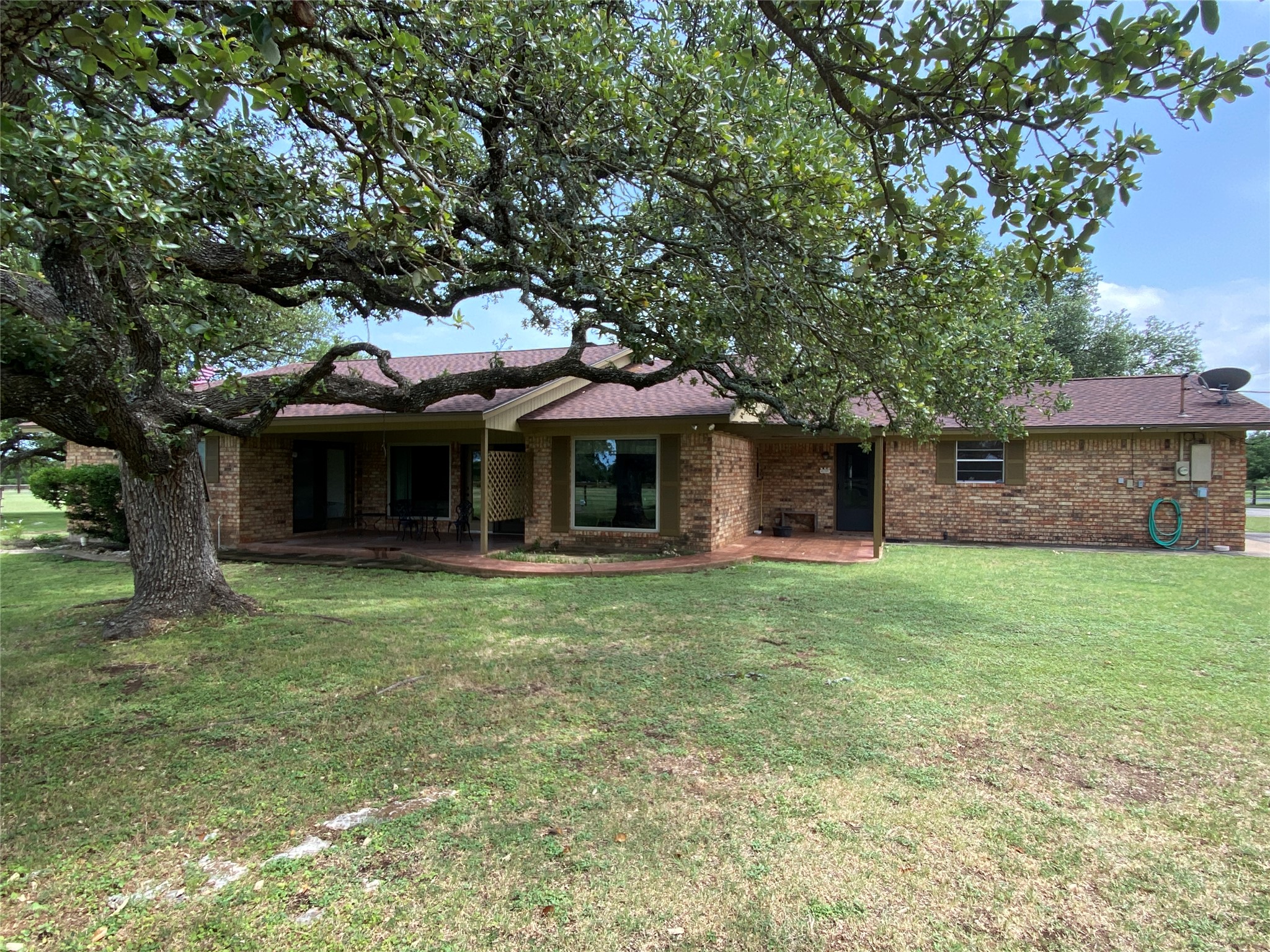 140 Oak Ridge Road Georgetown, TX 78628 - Photo 10 of 40 Rear view of house with a lawn and brick siding