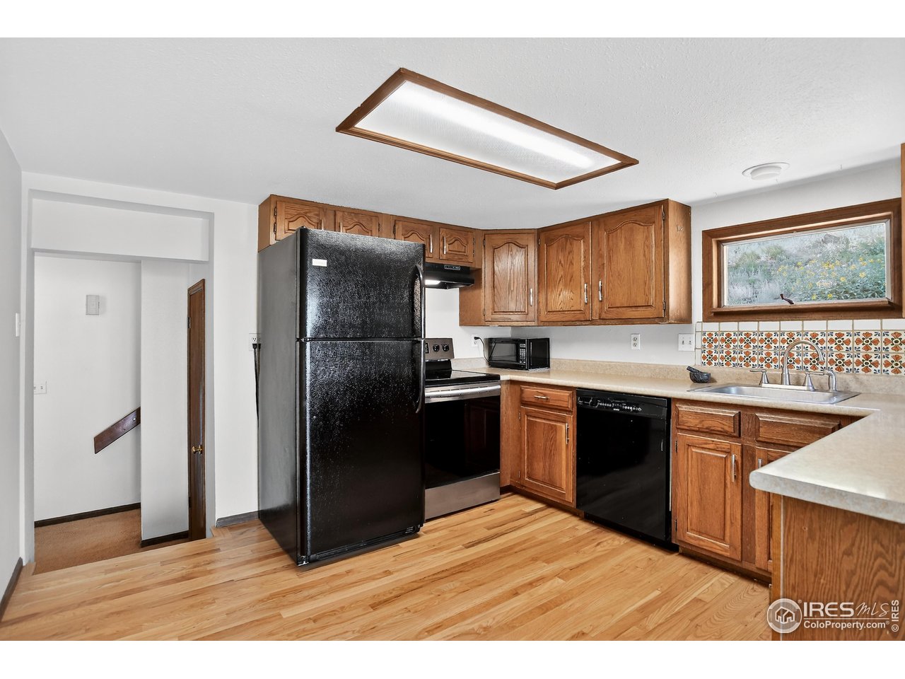 192 Nugget Hill Road Jamestown, CO 80455 - Photo 11 of 25 Kitchen with refrigerator, electric oven/stove, dishwasher, and microwave