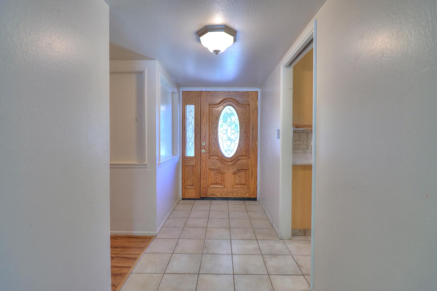 6265 North Colonial Avenue Fresno, CA 93704 - Photo 3 of 22 a view of a hallway with wooden door