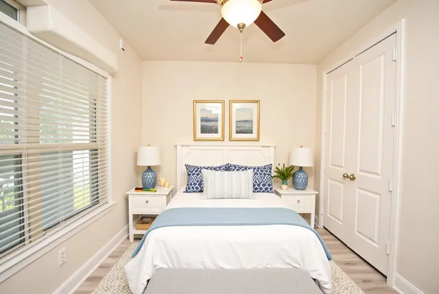 a bedroom with a bed and a window