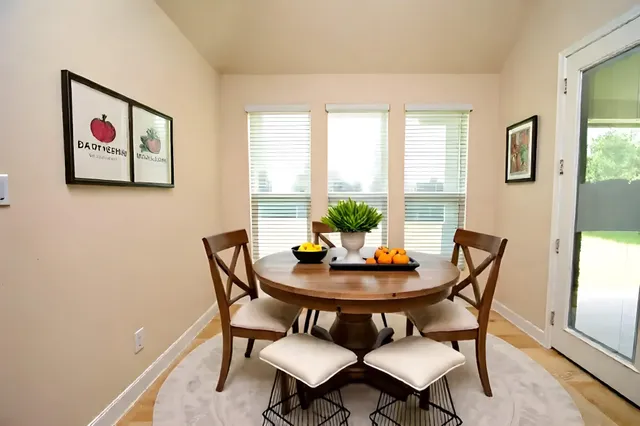 a dining room with furniture and window