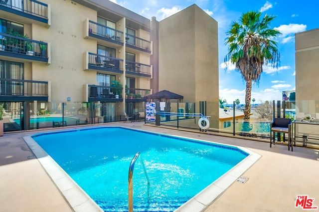 a swimming pool with outdoor seating and yard