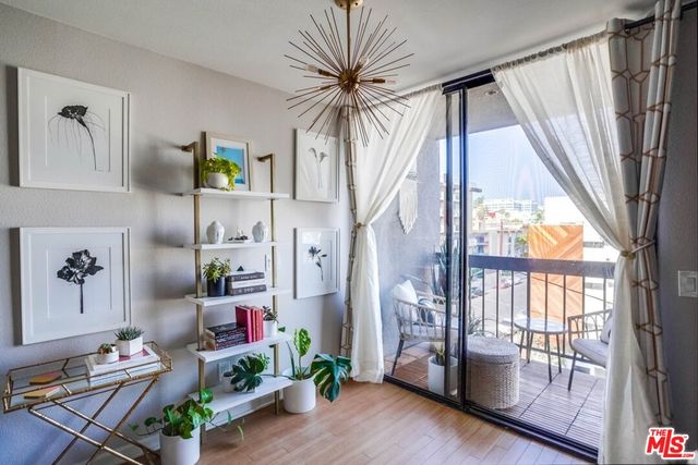 a living room with patio furniture and a floor to ceiling window