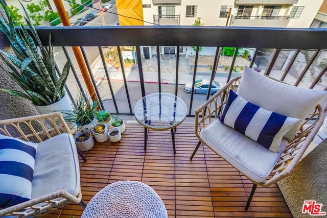 a view of living room with furniture and a potted plant