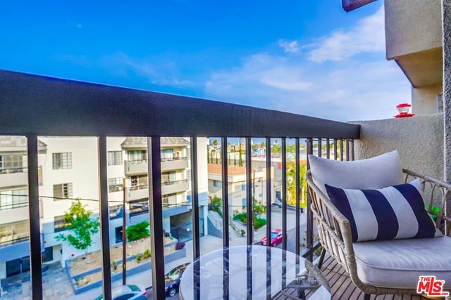 a balcony with furniture and wooden floor