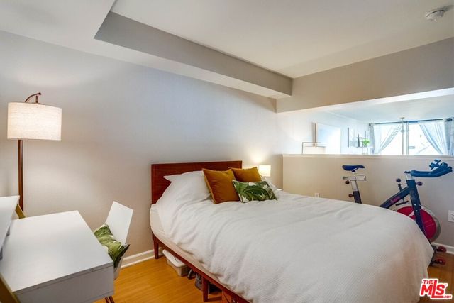 a bedroom with a bed and a lamp