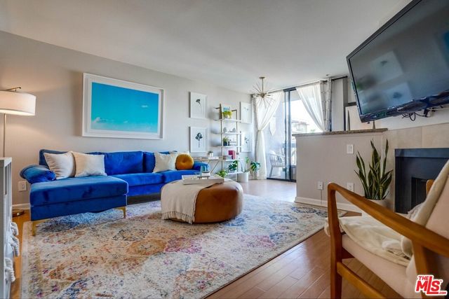 a living room with furniture flat screen tv and a window