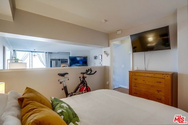 a bedroom with a bed and flat screen tv