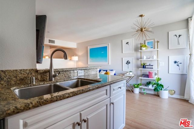 a kitchen with a sink a counter and cabinets