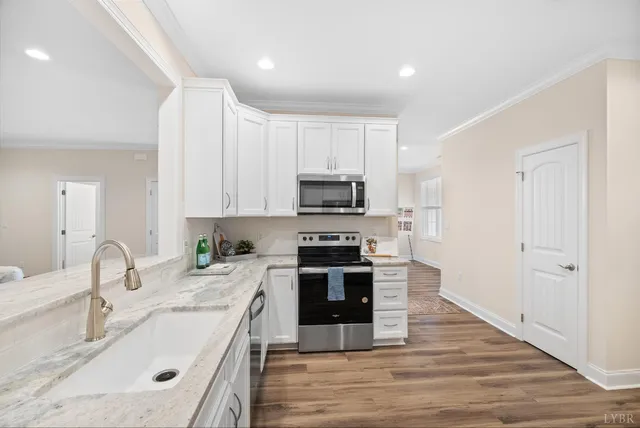 a kitchen with a sink and white cabinets