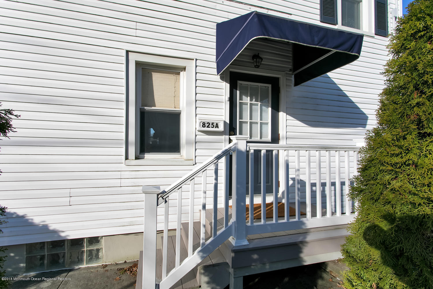 a view of a house with a small deck and a large window