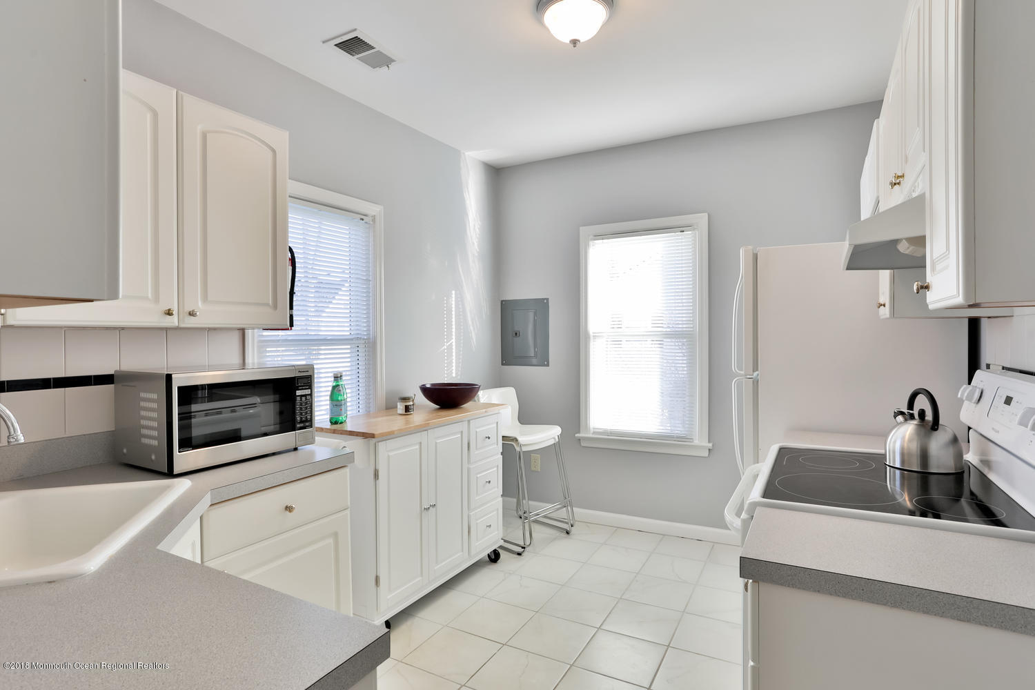 825 River Road, Unit A Fair Haven, NJ 07704 - Photo 4 of 11 a kitchen with white cabinets and white appliances