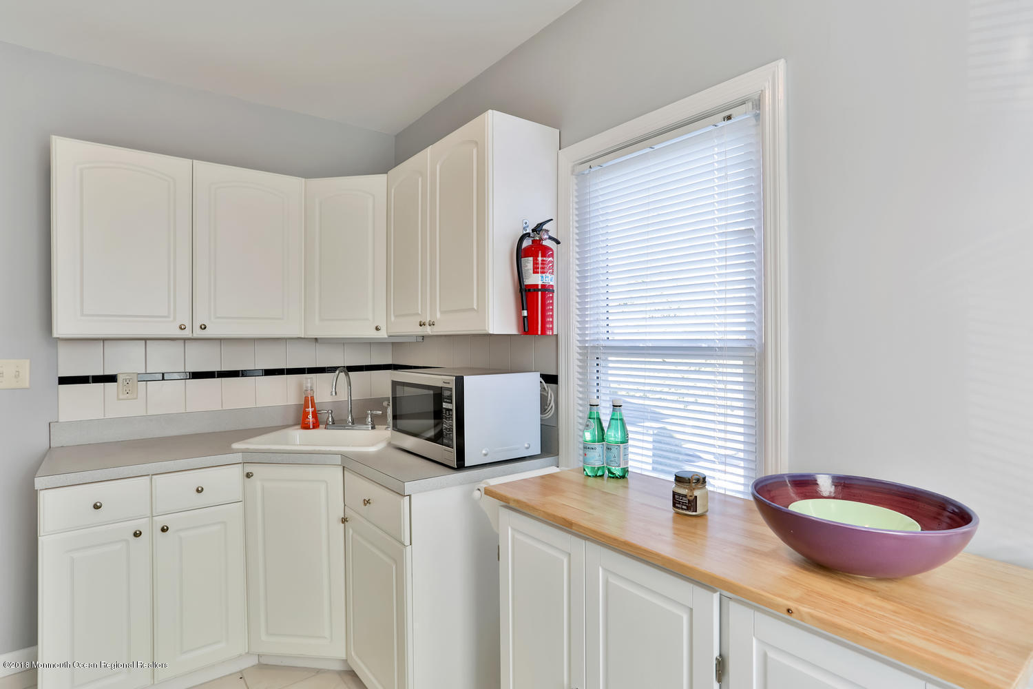 825 River Road, Unit A Fair Haven, NJ 07704 - Photo 5 of 11 a kitchen with white cabinets and sink