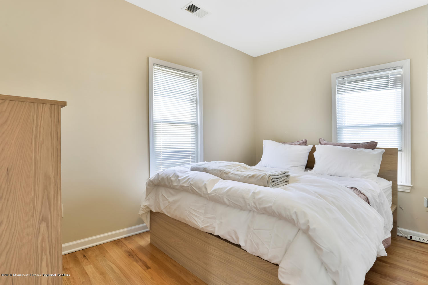 825 River Road, Unit A Fair Haven, NJ 07704 - Photo 6 of 11 a bedroom with a bed and a window