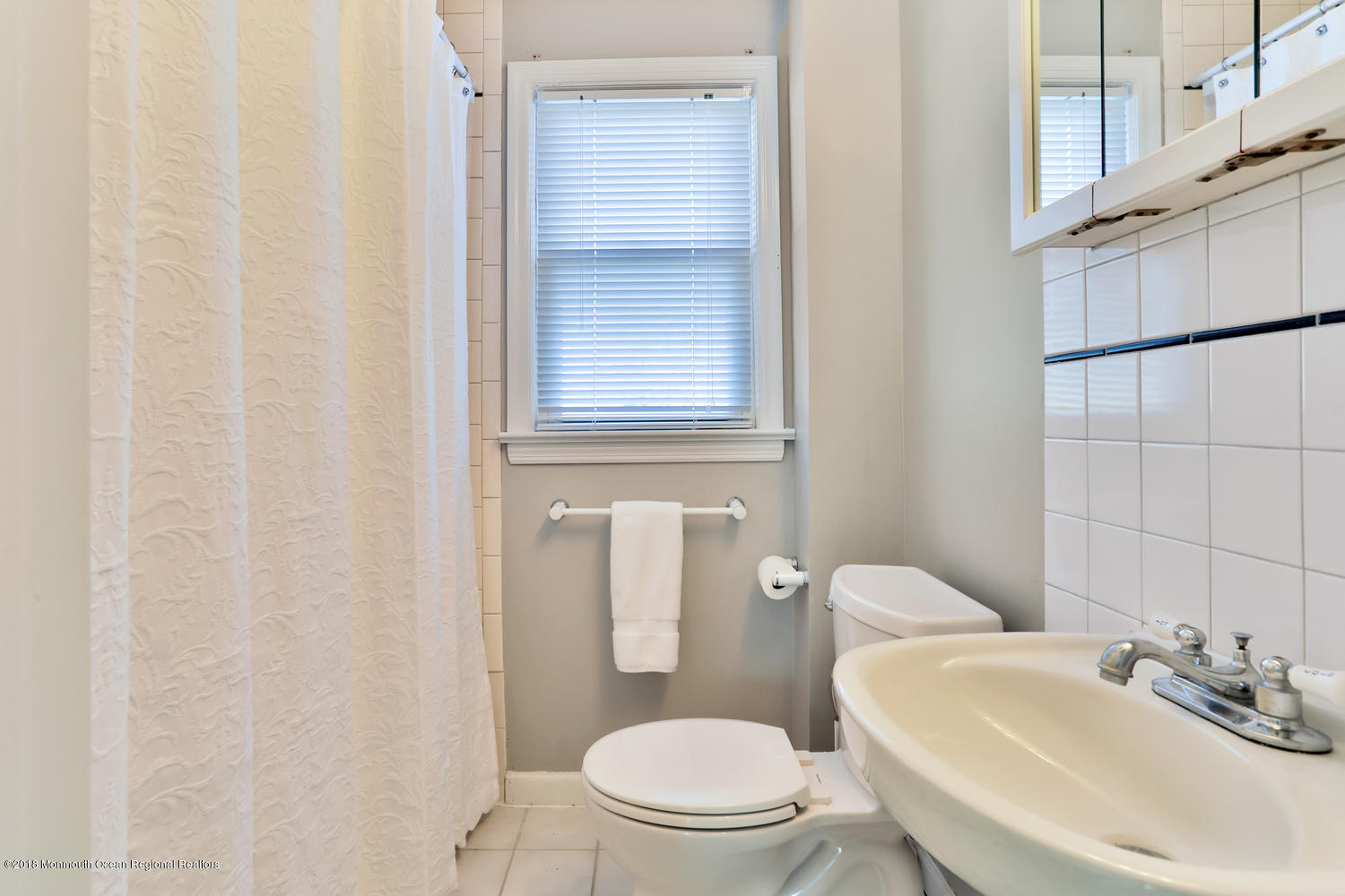 825 River Road, Unit A Fair Haven, NJ 07704 - Photo 9 of 11 a white toilet sitting next to a bathroom sink