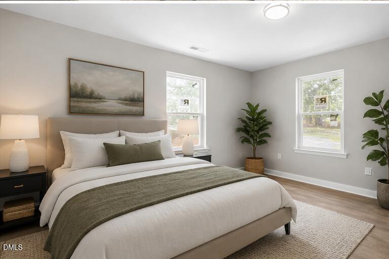 509 Sparella Street Durham, NC 27703 - Photo 19 of 30 a bedroom with a large bed and a window