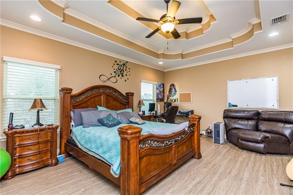 1306 Keenland Road Corpus Christi, TX 78418 - Photo 10 of 26 a bedroom with furniture and a wooden floor