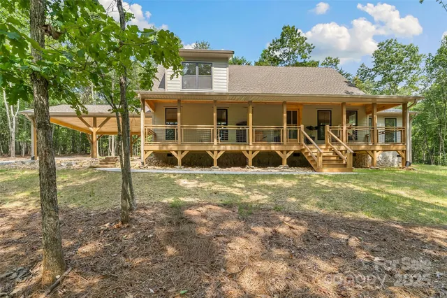 a view of a house with a yard and sitting area