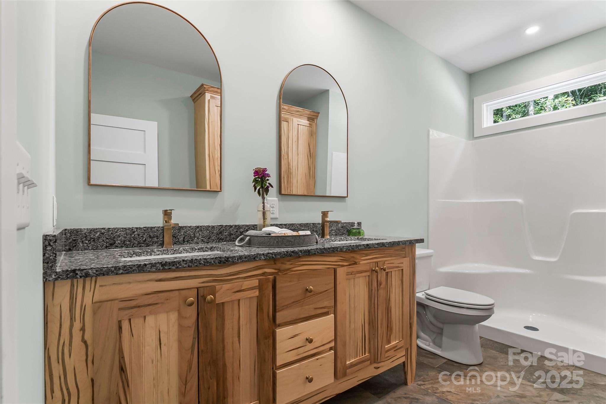 5251 Mt Olive Church Road Morganton, NC 28655 - Photo 17 of 43 a bathroom with a granite countertop toilet a sink and a mirror