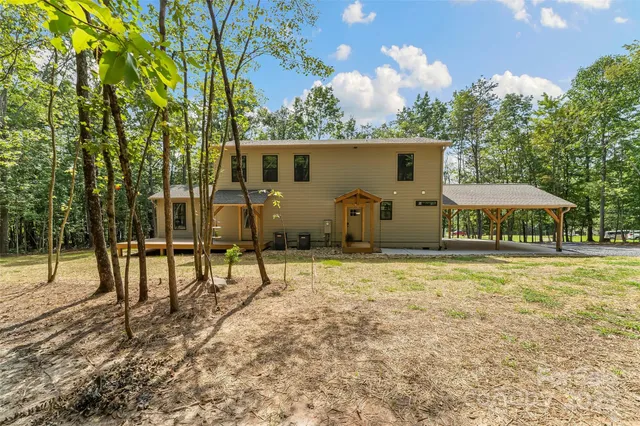 a view of a house with backyard and sitting area
