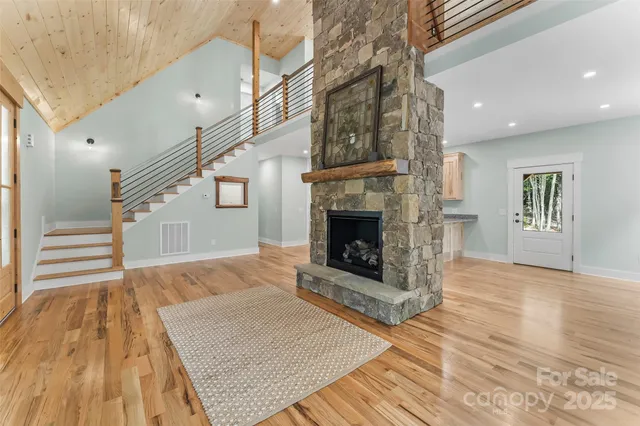 a view of empty room with wooden floor and fireplace