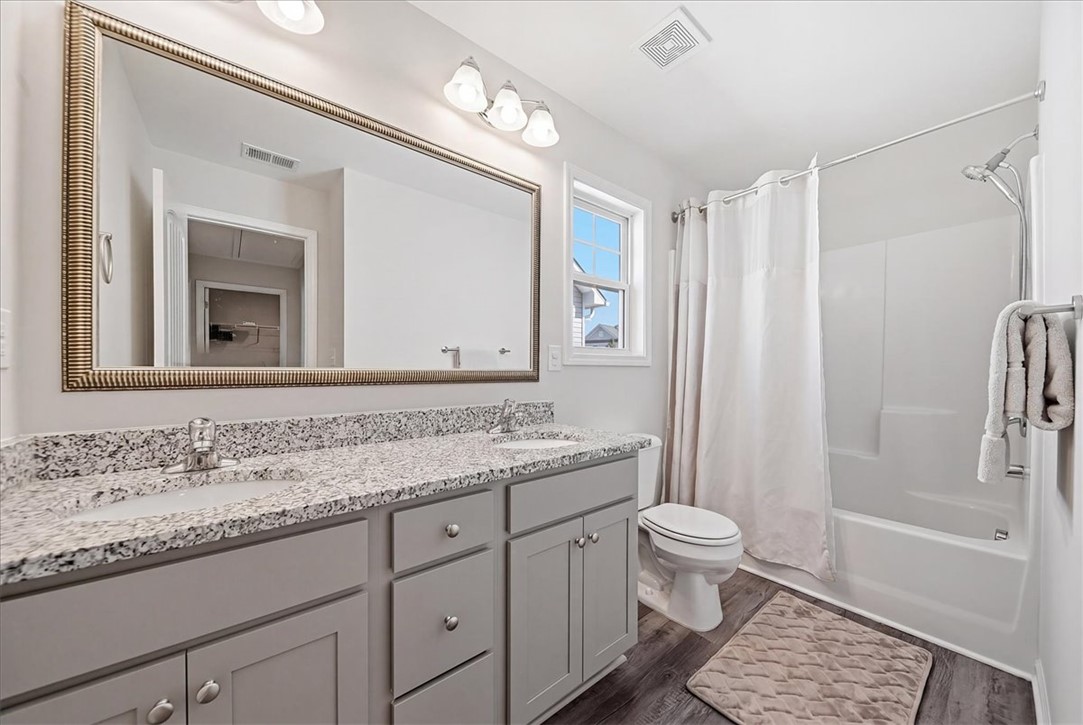 403 Seaborn Circle Pendleton, SC 29670 - Photo 22 of 47 This functional bathroom features a dual vanity with ample counter space and a classic tub-shower combination.