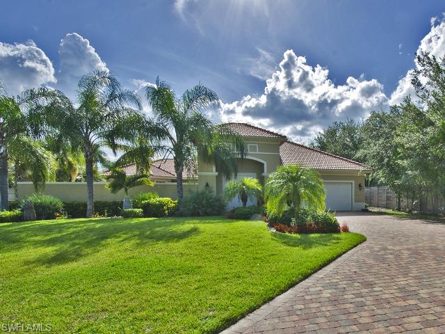 5030 Rustic Oaks Circle Naples, FL 34105 - Photo 1 of 12 a front view of a house with garden