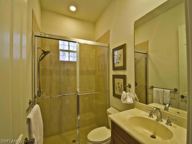 5030 Rustic Oaks Circle Naples, FL 34105 - Photo 11 of 12 a bathroom with a sink toilet and shower