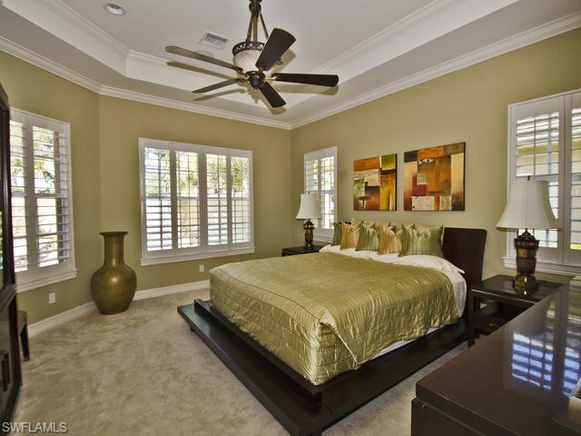 5030 Rustic Oaks Circle Naples, FL 34105 - Photo 8 of 12 a bedroom with bed and window