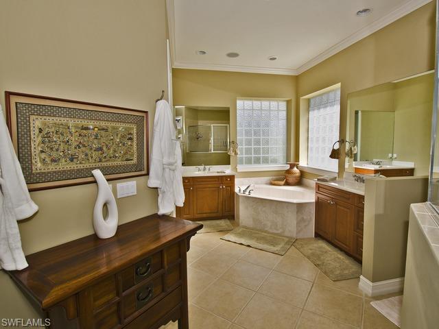 5030 Rustic Oaks Circle Naples, FL 34105 - Photo 9 of 12 a large white kitchen with a large window