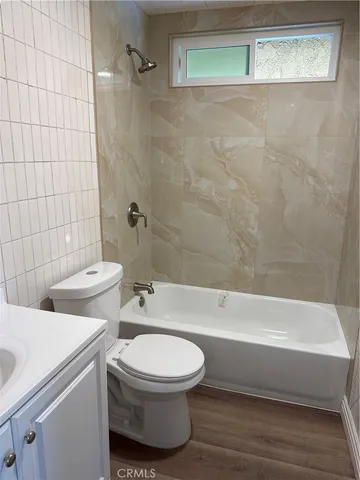 a bathroom with a toilet and a bath tub