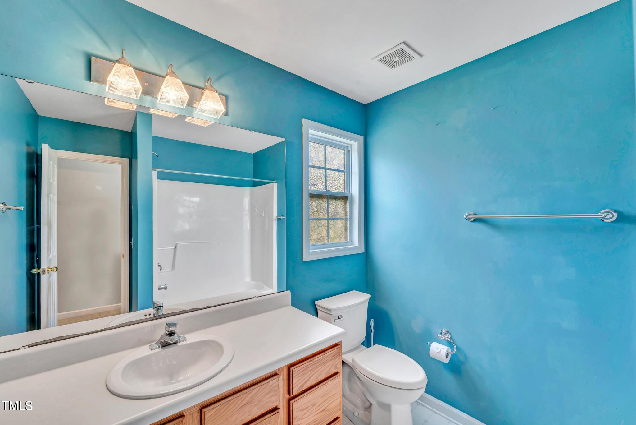2505 Tryon Pines Drive Raleigh, NC 27603 - Photo 13 of 21 a bathroom with a sink a toilet and mirror