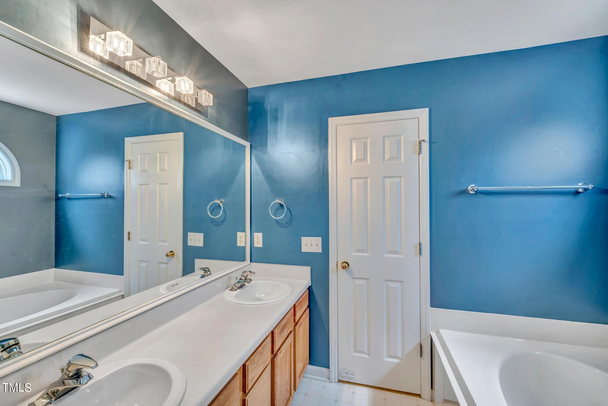 2505 Tryon Pines Drive Raleigh, NC 27603 - Photo 16 of 21 a en suite bathroom with a granite countertop tub sink and mirror