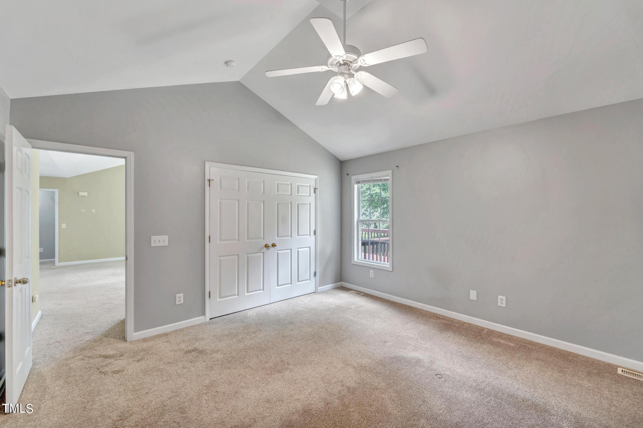 2505 Tryon Pines Drive Raleigh, NC 27603 - Photo 17 of 21 an empty room with chandelier fan and windows