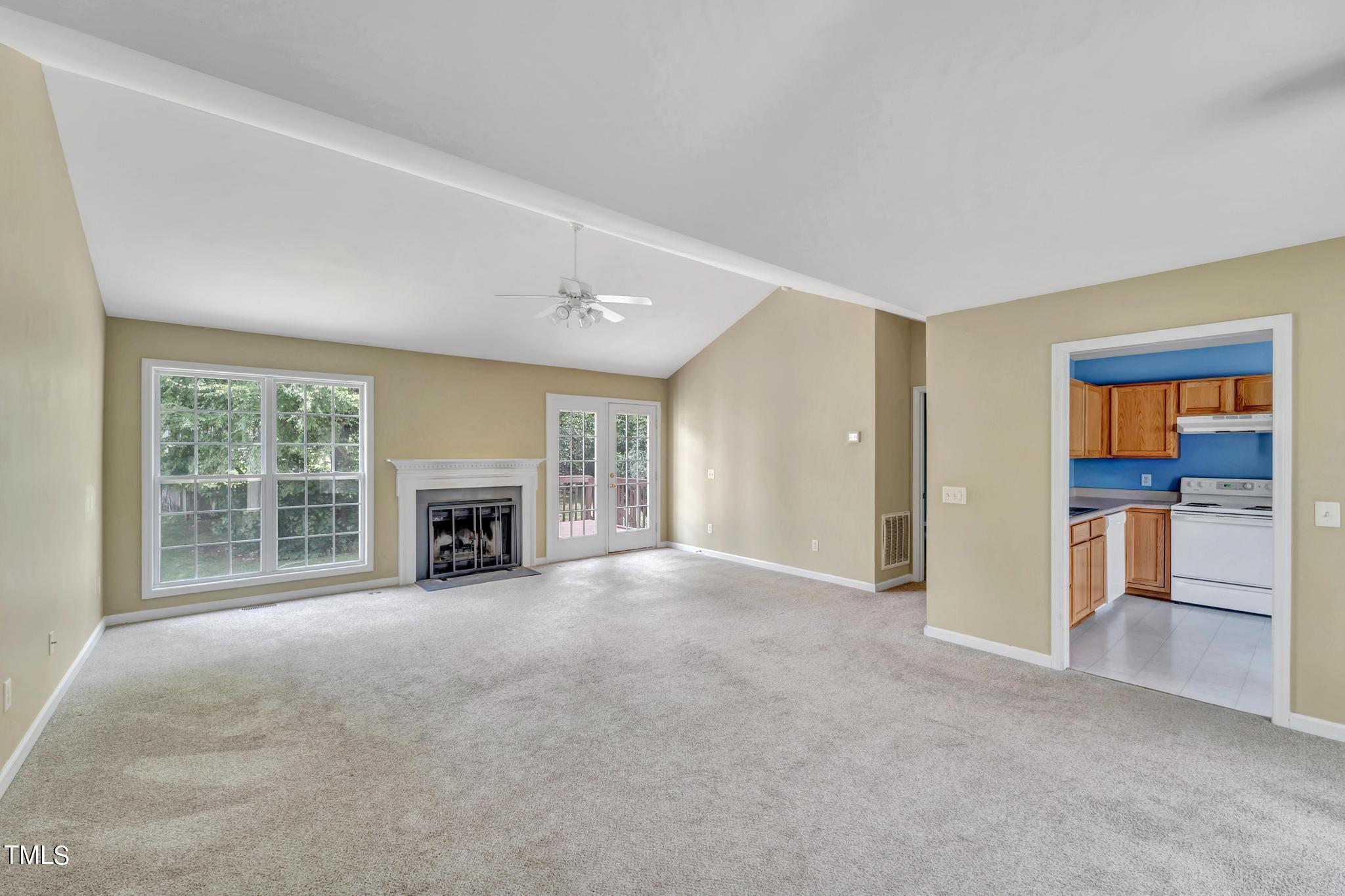 2505 Tryon Pines Drive Raleigh, NC 27603 - Photo 4 of 21 an empty room with furniture and a fireplace