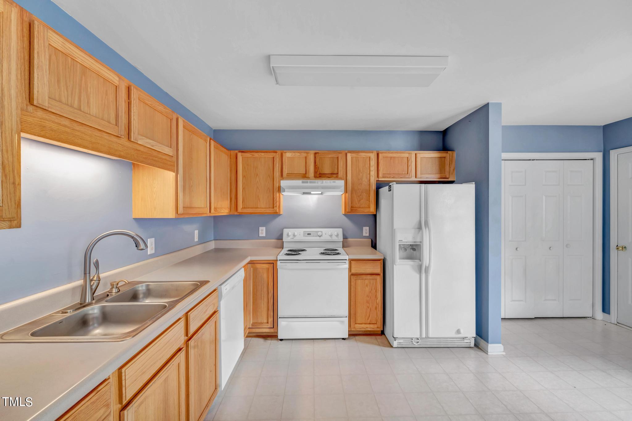 2505 Tryon Pines Drive Raleigh, NC 27603 - Photo 8 of 21 a kitchen with a sink cabinets and refrigerator