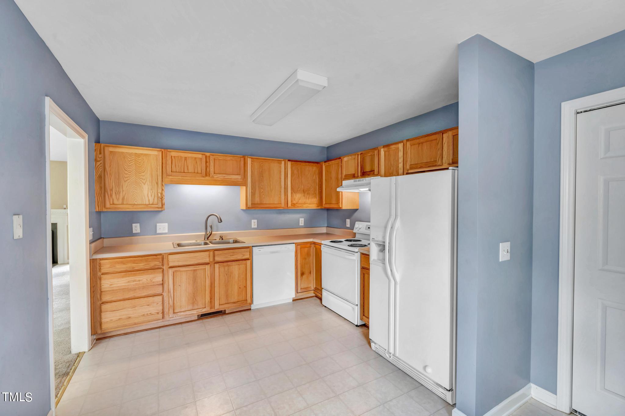2505 Tryon Pines Drive Raleigh, NC 27603 - Photo 9 of 21 a kitchen with stainless steel appliances a refrigerator sink and window