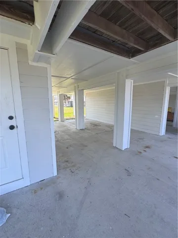 a view of an empty room with a fireplace and a window