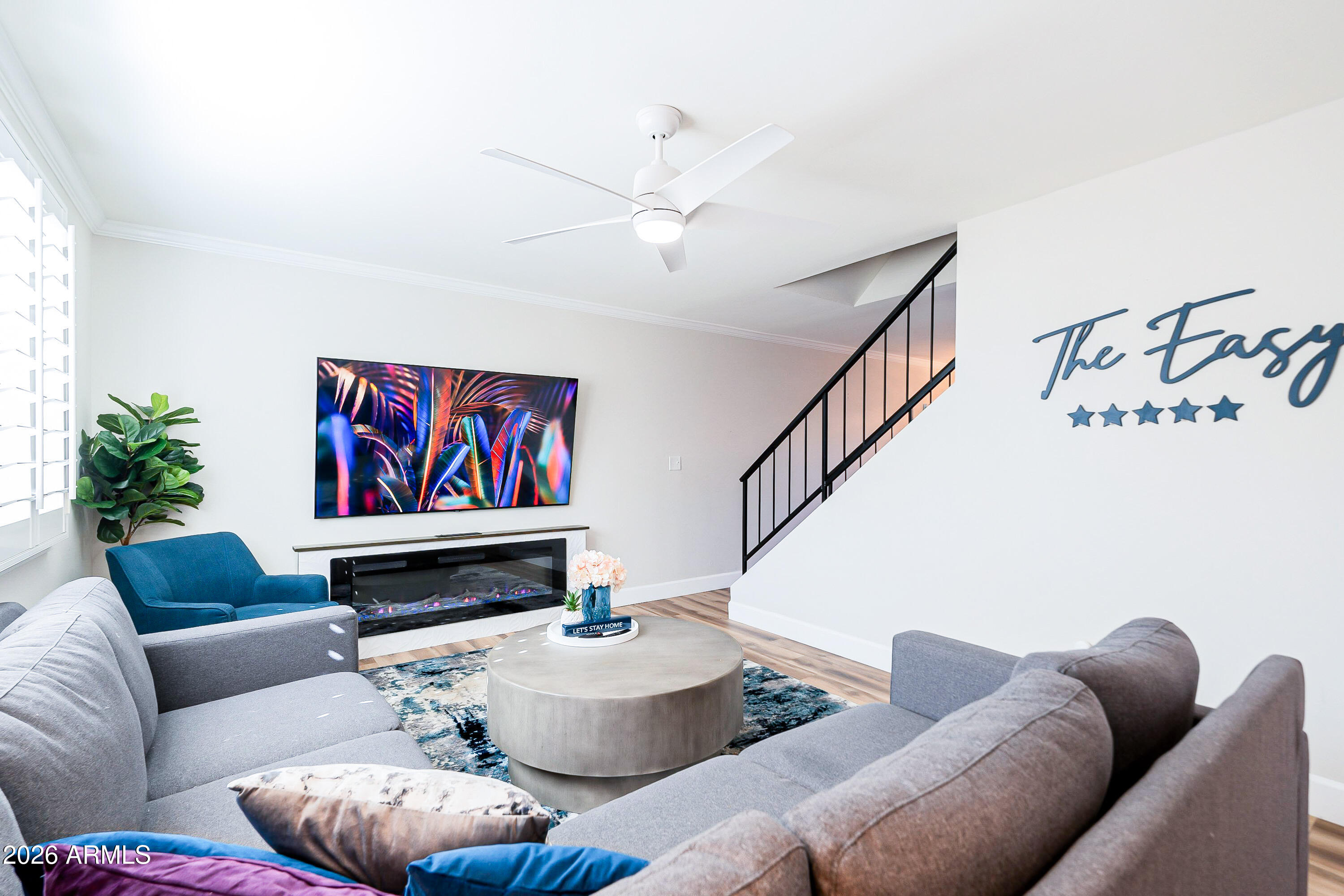 a living room with furniture and a potted plant