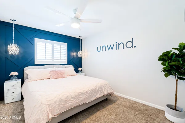 a bedroom with a bed and a potted plant